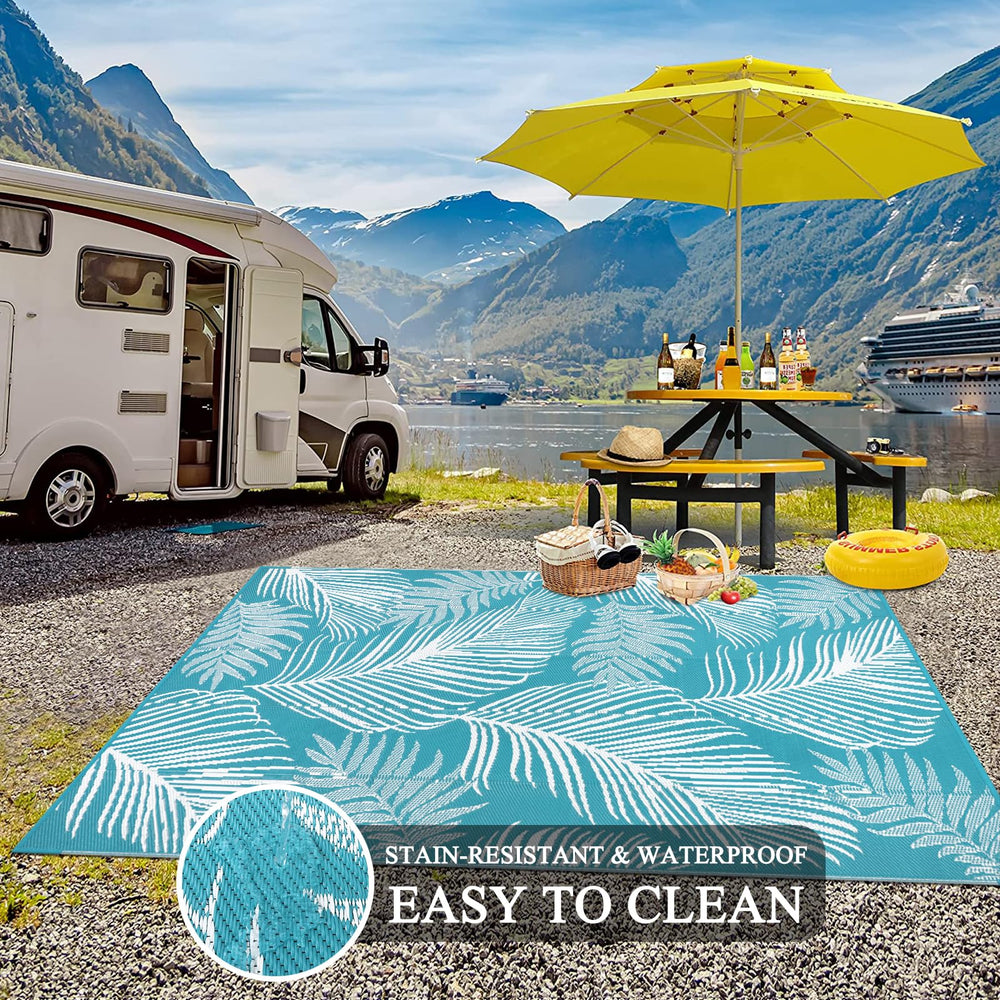 Pauwer Outdoor Rug Leaf Teal with rug stakes for secure placement
