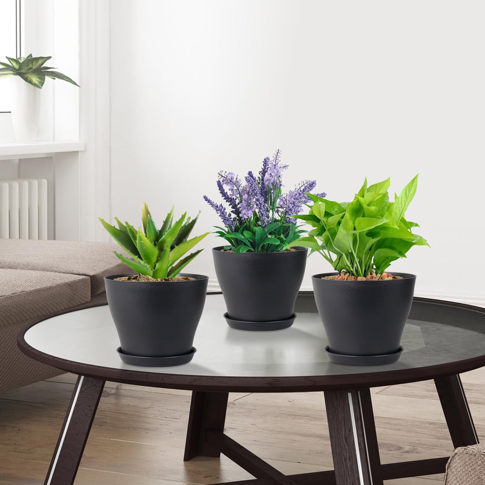 Person painting Meowell nursery pots for decoration