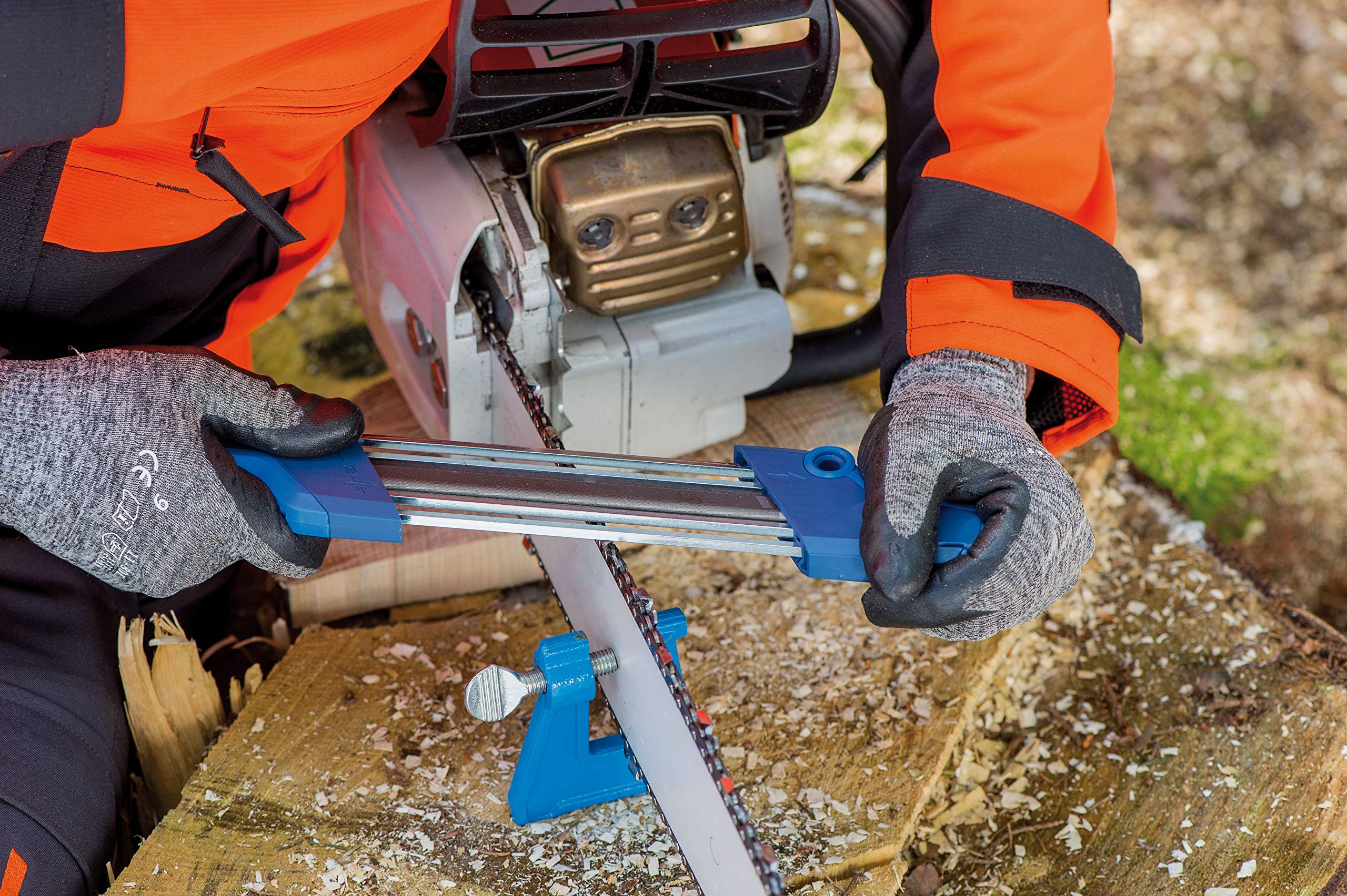PFERD filing vise installed in a log for sharpening chainsaw