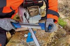 PFERD filing vise installed in a log for sharpening chainsaw