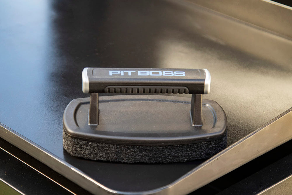 PIT BOSS Griddle Cleaning Brush showing the plastic handle and scouring pad