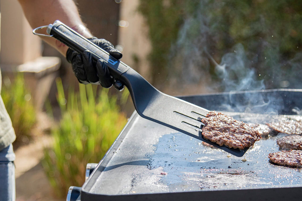 PIT BOSS griddle scraper demonstrating its chopping capability