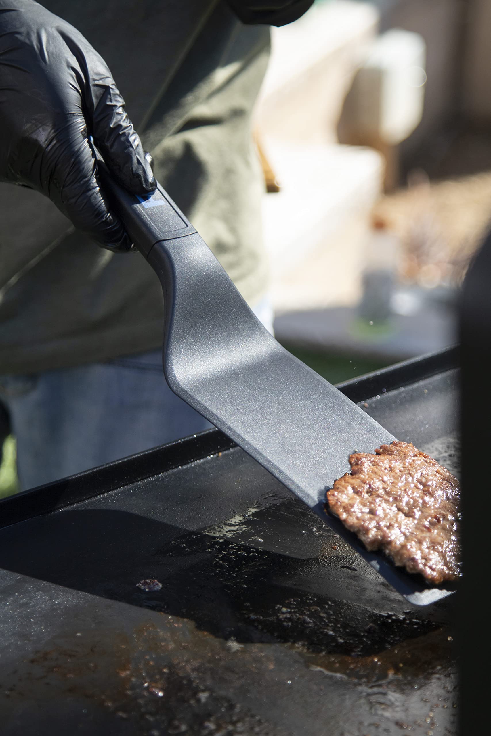 PIT BOSS griddle tools being used for outdoor cooking