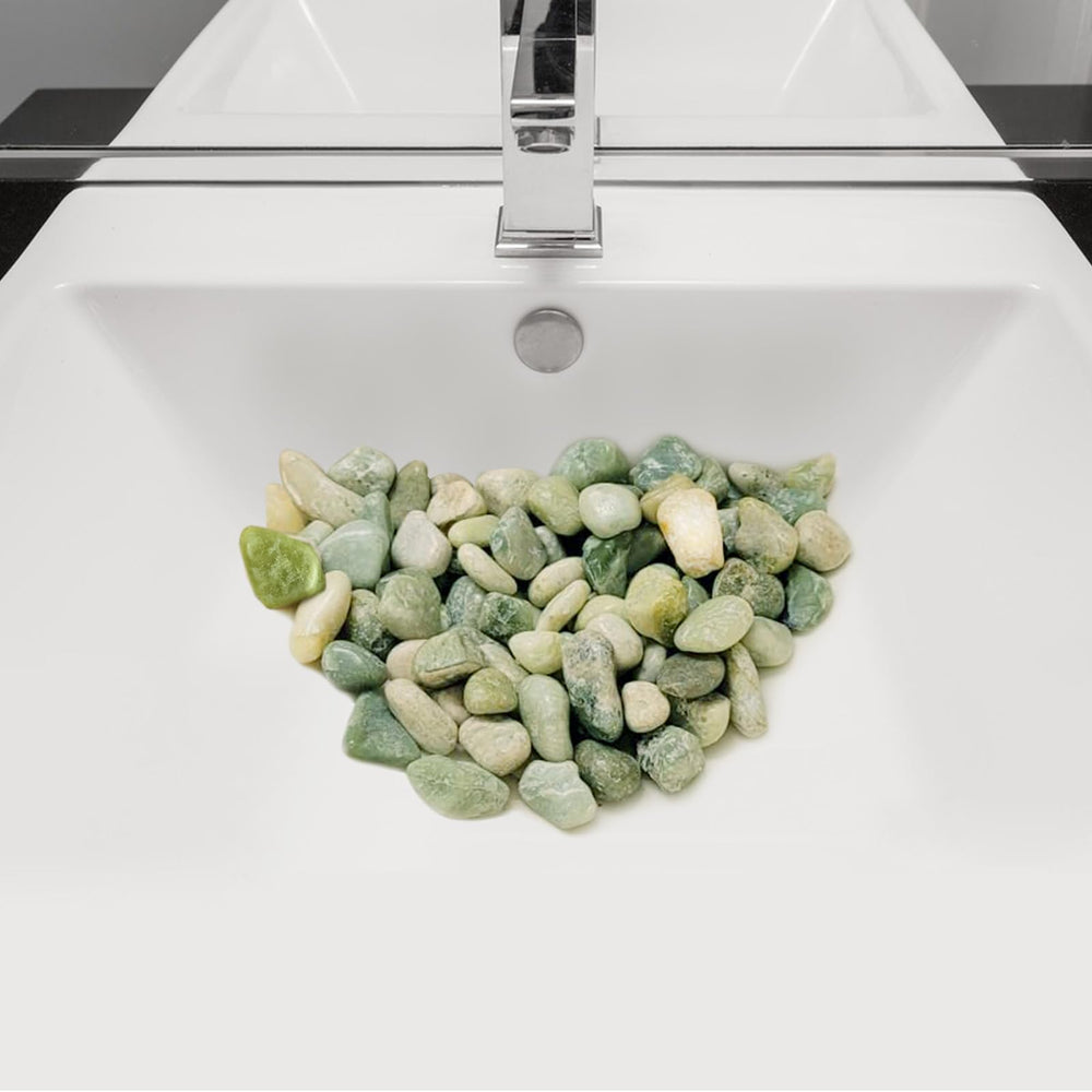 Polished jade stones in a decorative vase