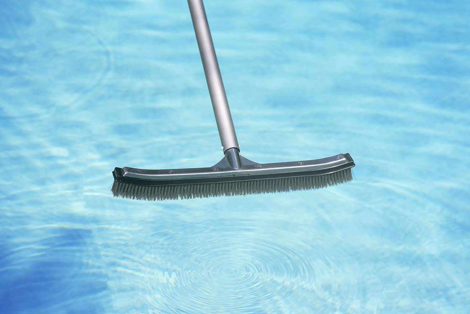 Poolmaster brush in action cleaning a pool wall