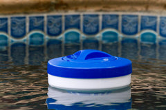 Poolmaster chlorine dispenser floating in a pool
