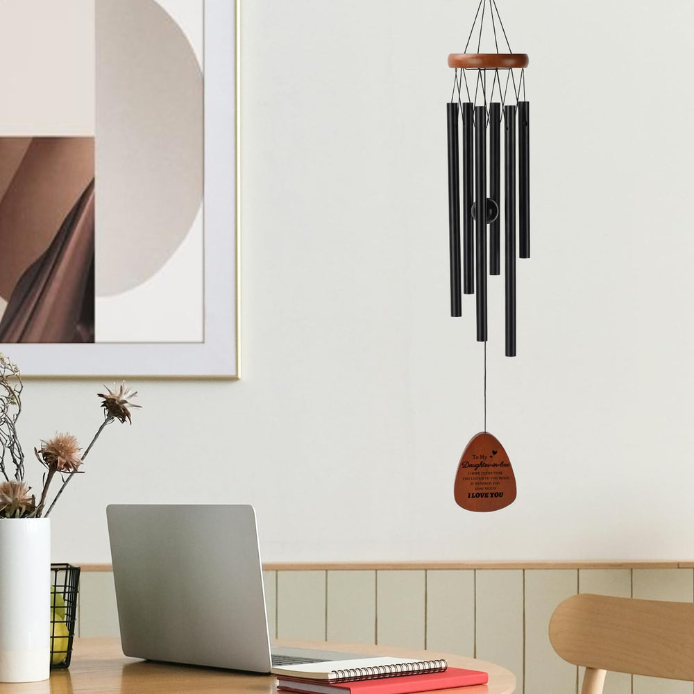 PRSTENLY wind chimes hanging from a porch with a serene background
