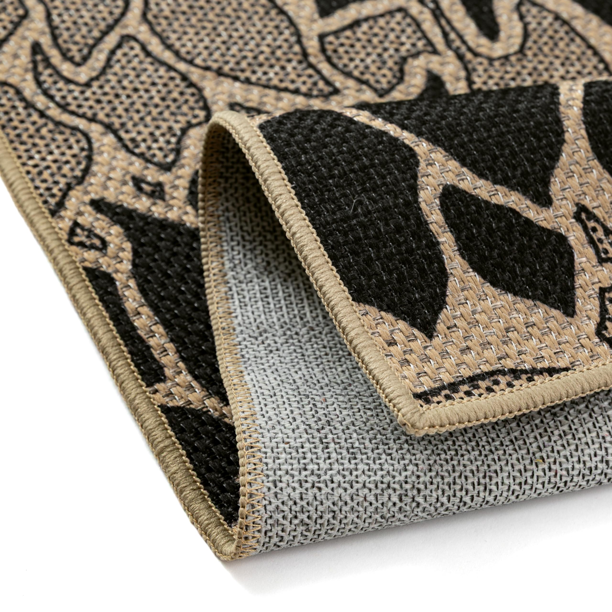 PureCozy 5x8 Black Outdoor Rug on patio
