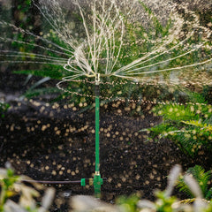 Restmo 3-Arm Sprinkler on green lawn in use
