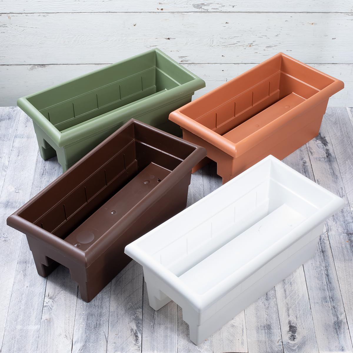 Root & Vessel planter box with plants inside on a railing