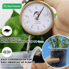 RooTrimmer clear seeding pots in a garden setting