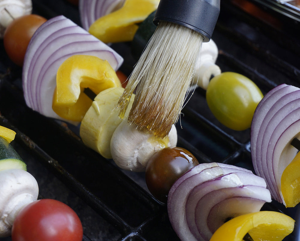 RSVP BBQ Basting Brush placed next to grilling tools