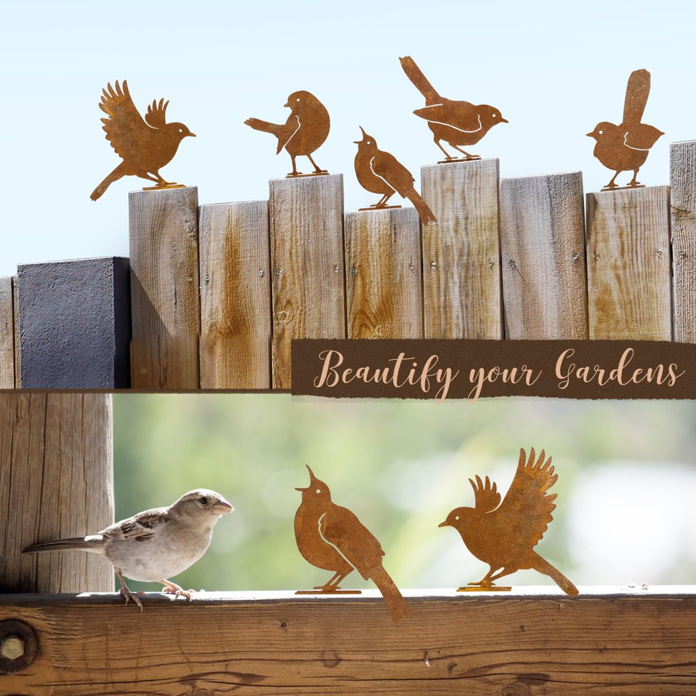Rusty metal birds displayed on a garden gate