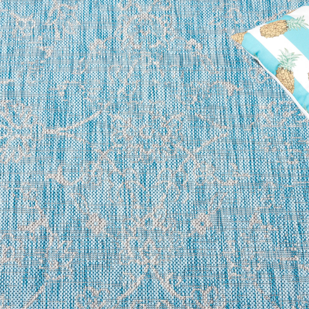 SAFAVIEH Outdoor Rug Aqua/Grey rolled for storage
