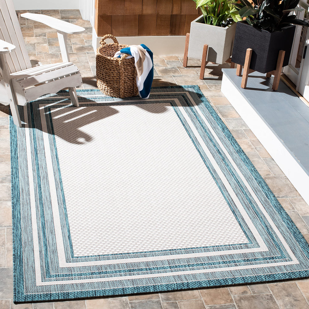 SAFAVIEH Washable Outdoor Rug front view in Ivory and Teal