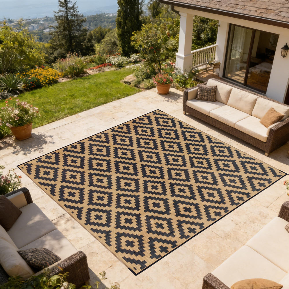 SAND MINE Outdoor Rug being cleaned with a hose