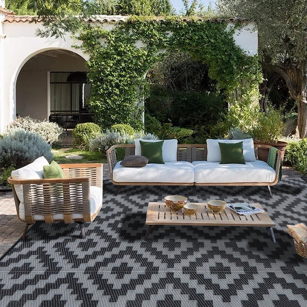 SAND MINE outdoor rug on the beach, black grey pattern