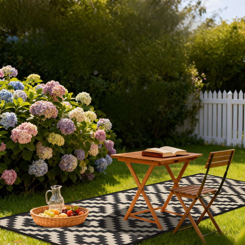 SAND MINE Reversible Outdoor Rug on grass showing softness