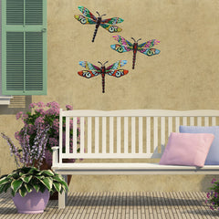 Scwhousi Metal Dragonfly Wall Decor hanging on a garden fence