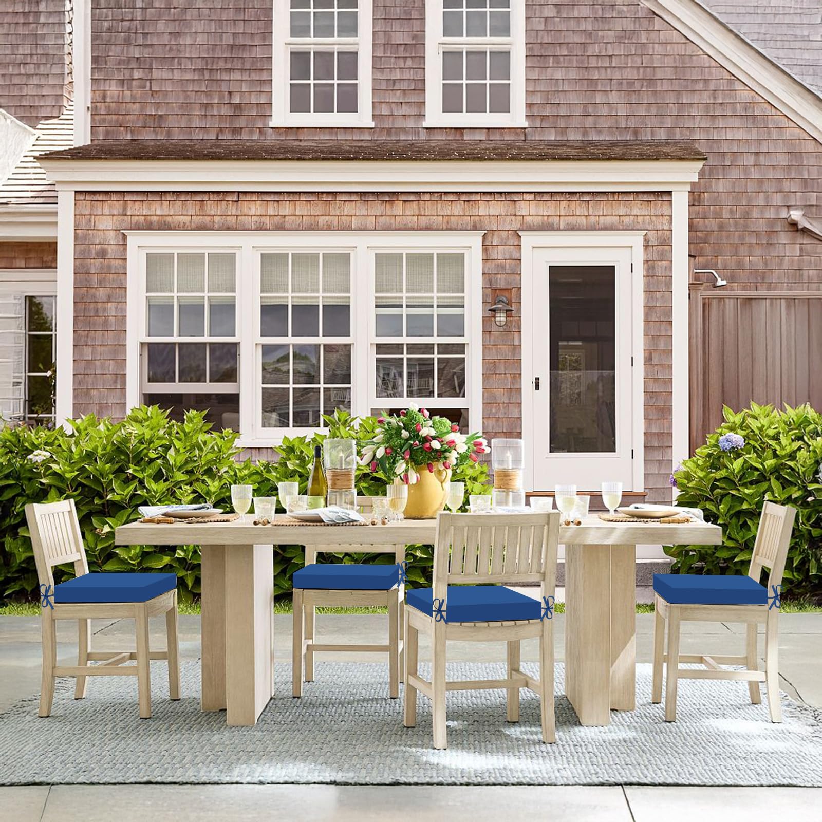 Set of 4 Basic Beyond outdoor chair cushions displayed outdoors