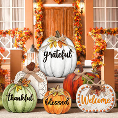 Set of 6 wooden pumpkin signs arranged on a porch