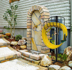 Side view of Artigarden garden hose holder in outdoor setting