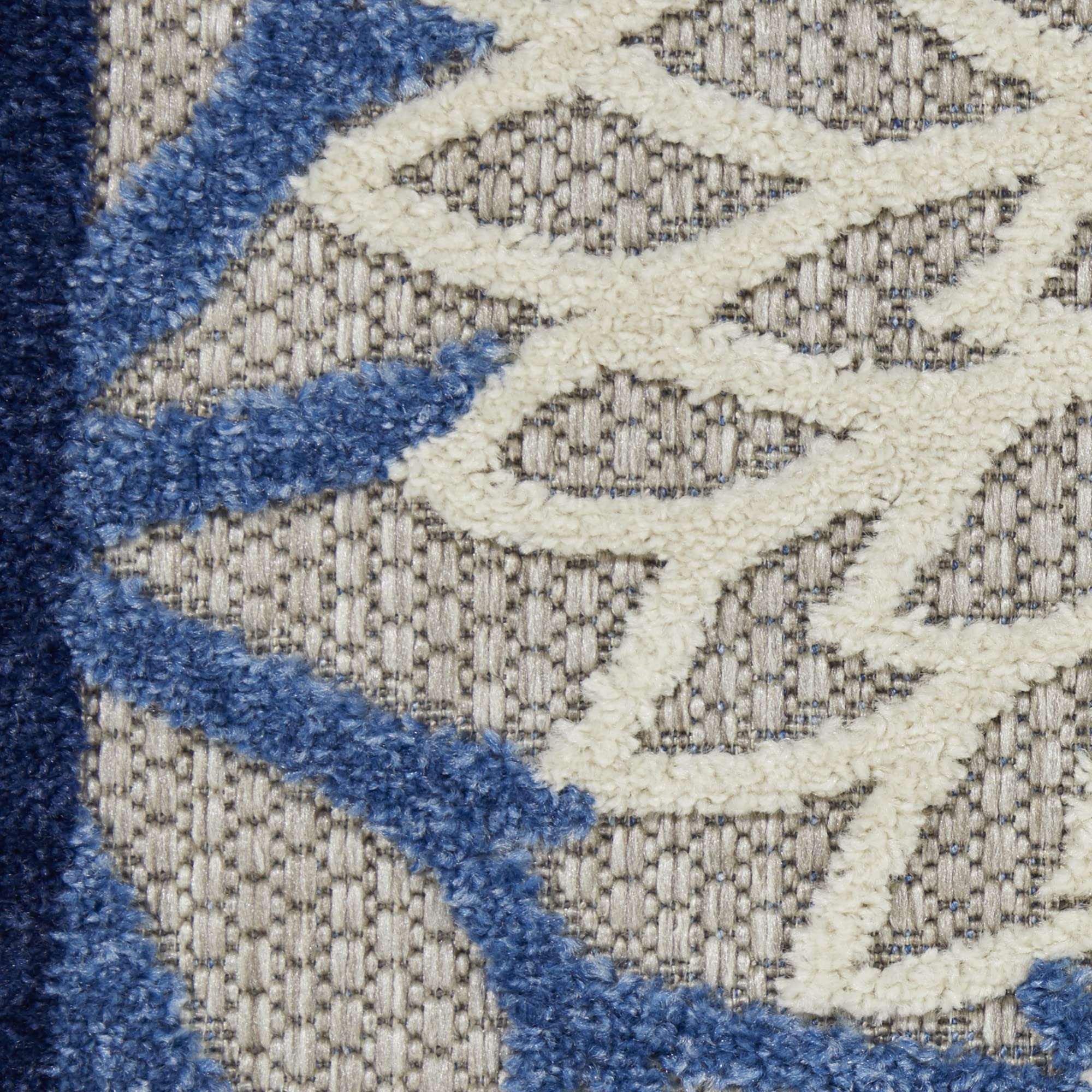 Side view of Nourison Aloha area rug highlighting its flat weave