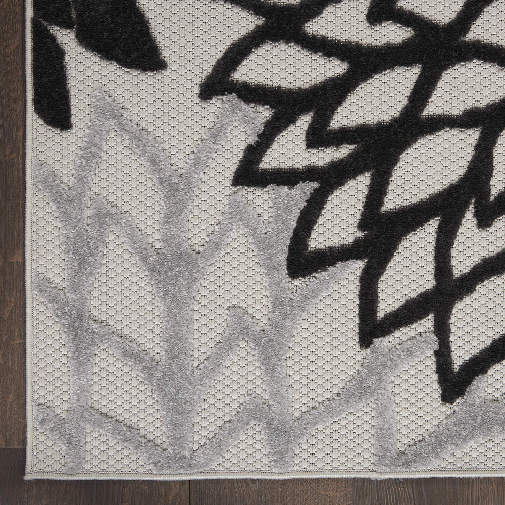 Side view of Nourison Aloha area rug showing its flat weave