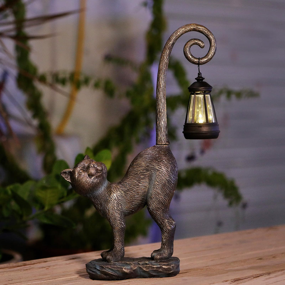 Side view of REYISO Cat Statue in garden setting
