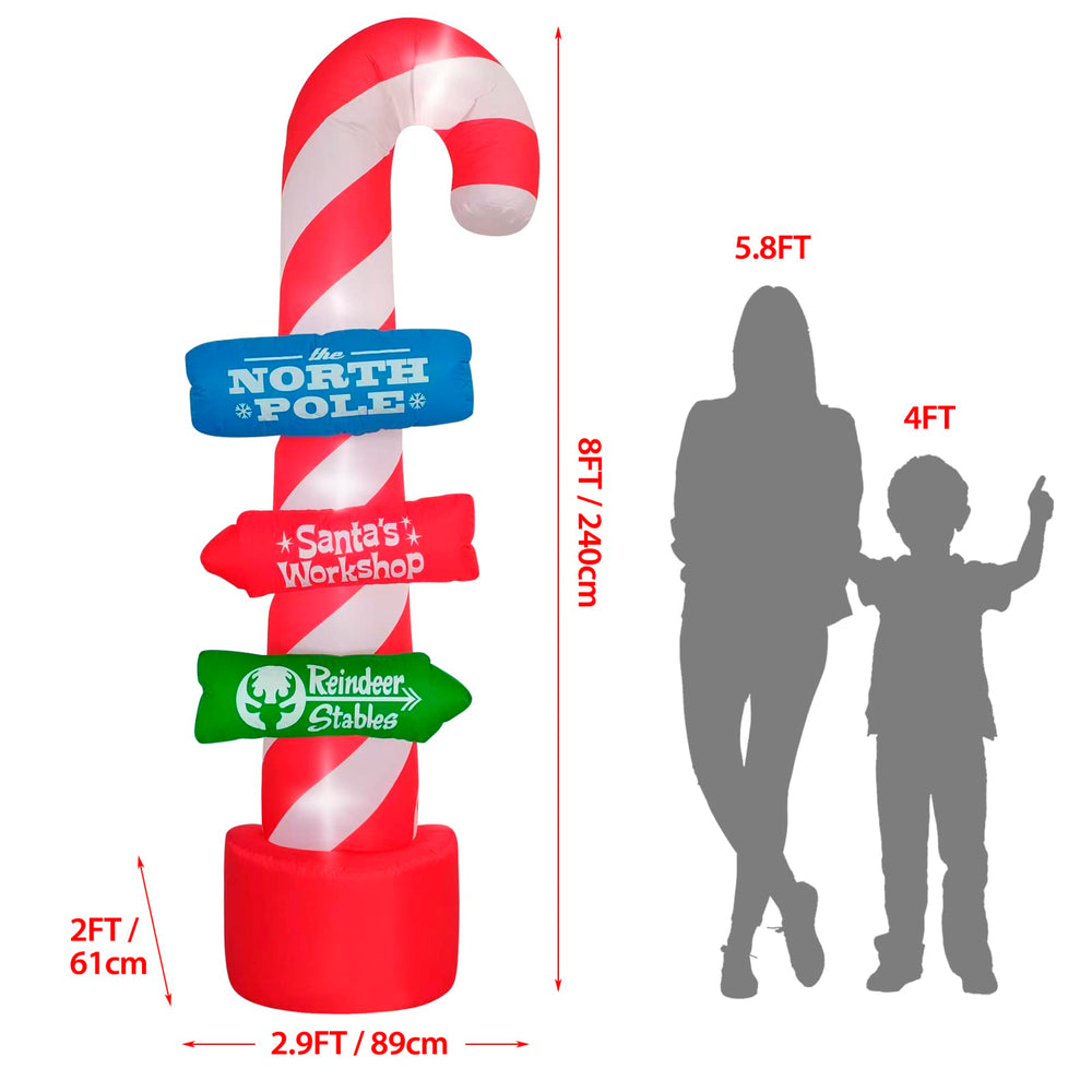 Side view of SHDEJTG inflatable candy cane sign in garden