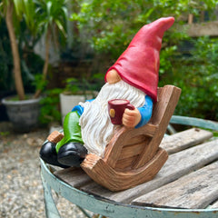 Side view of the 7.1-inch gnome statue in a garden setting