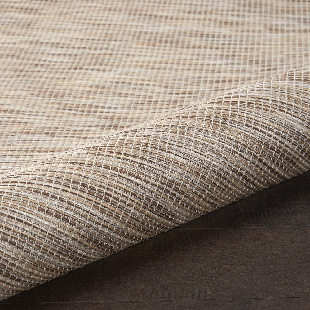 Side view of the Nourison Positano rug showing flat weave