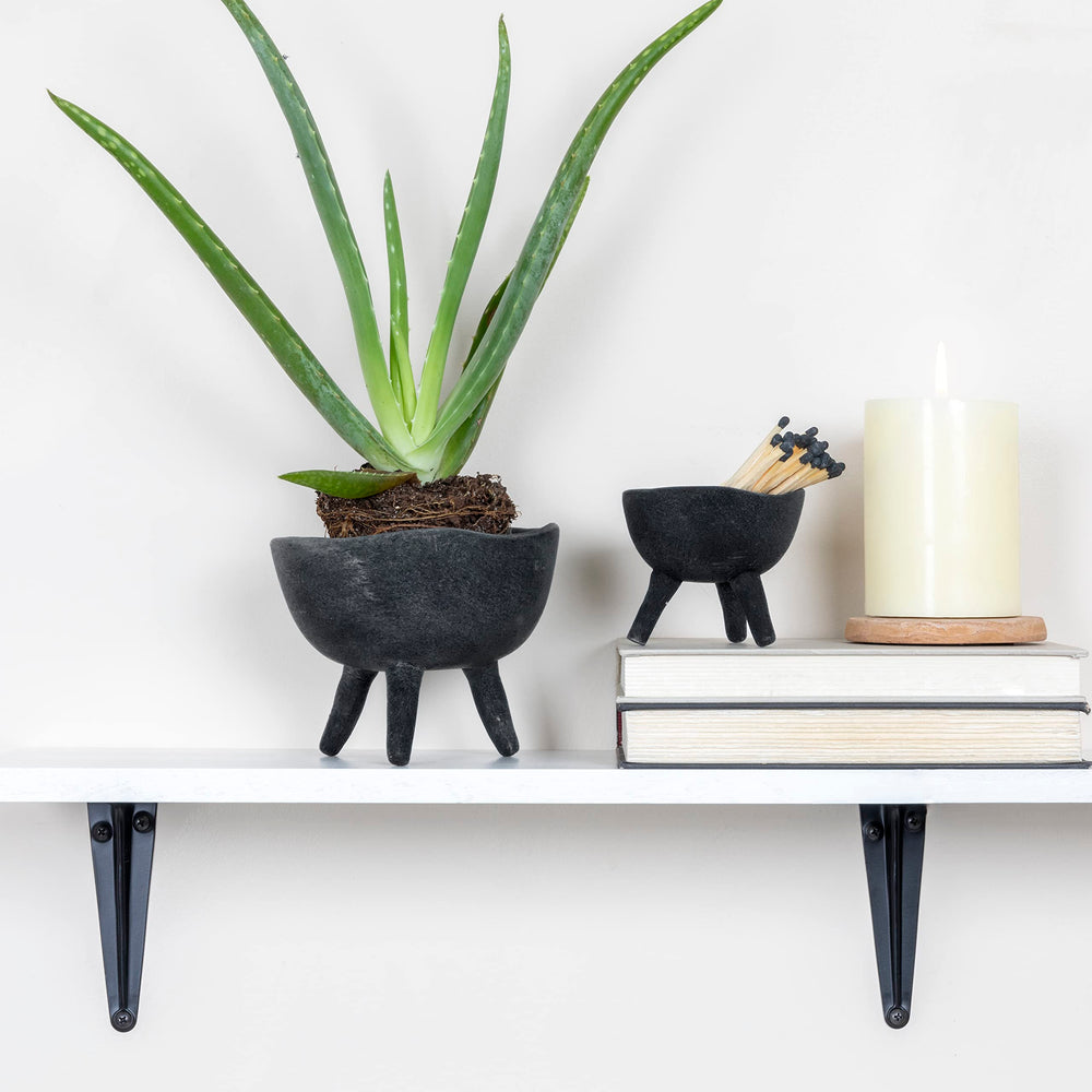 Slate grey footed planter with small plant inside