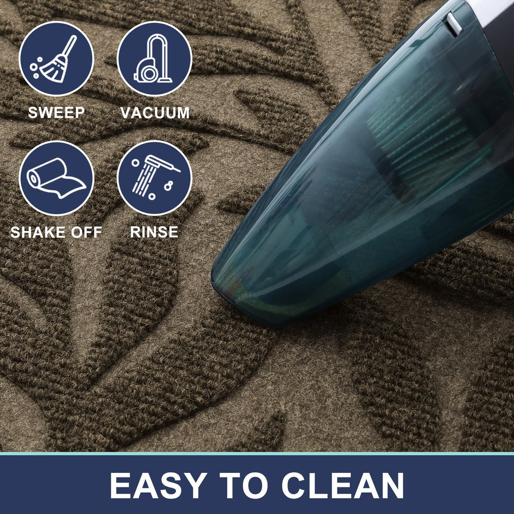 Smiry Leaf Front Door Mat 47x17 being cleaned with a hose