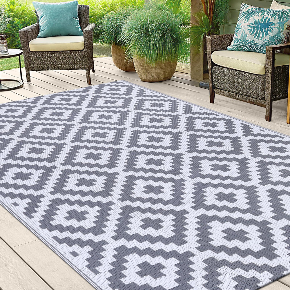 Smiry Outdoor Rug 5x8 ft laid out on a beach picnic