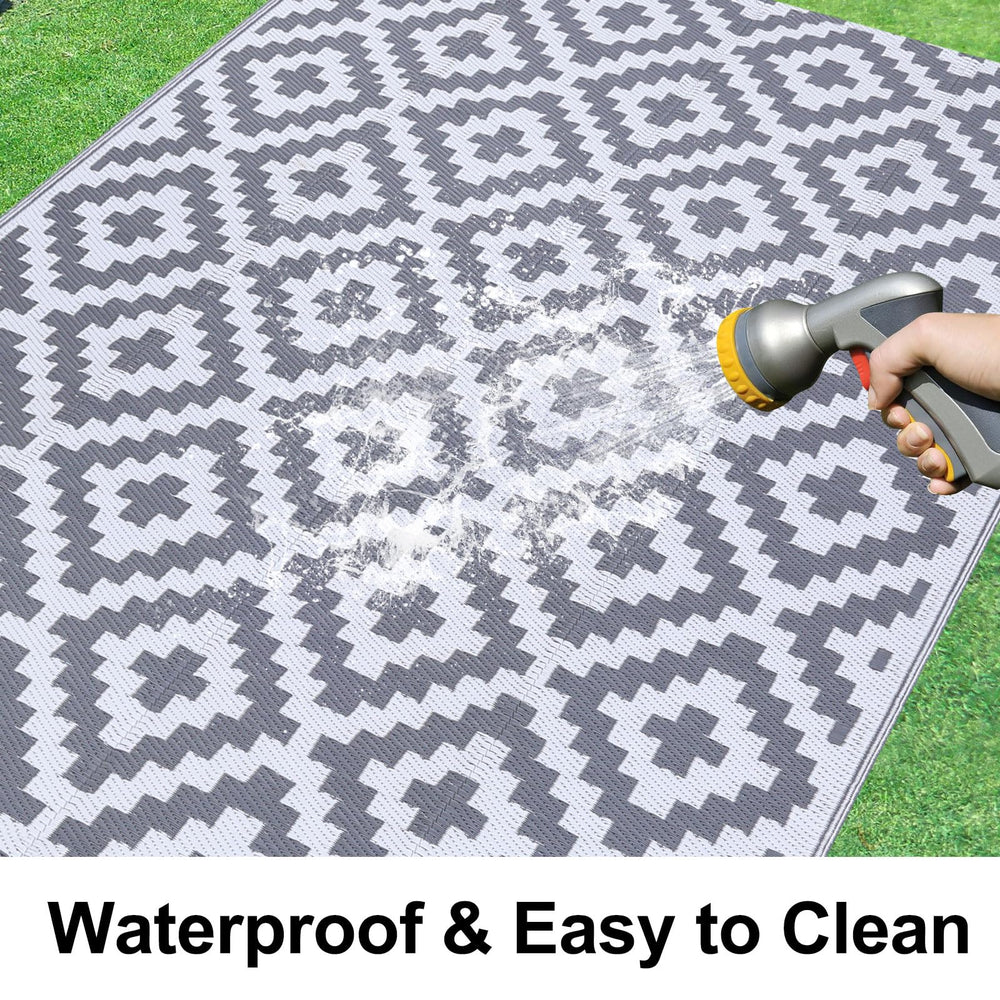 Smiry Outdoor Rug 5x8 ft showing waterproof feature with hose