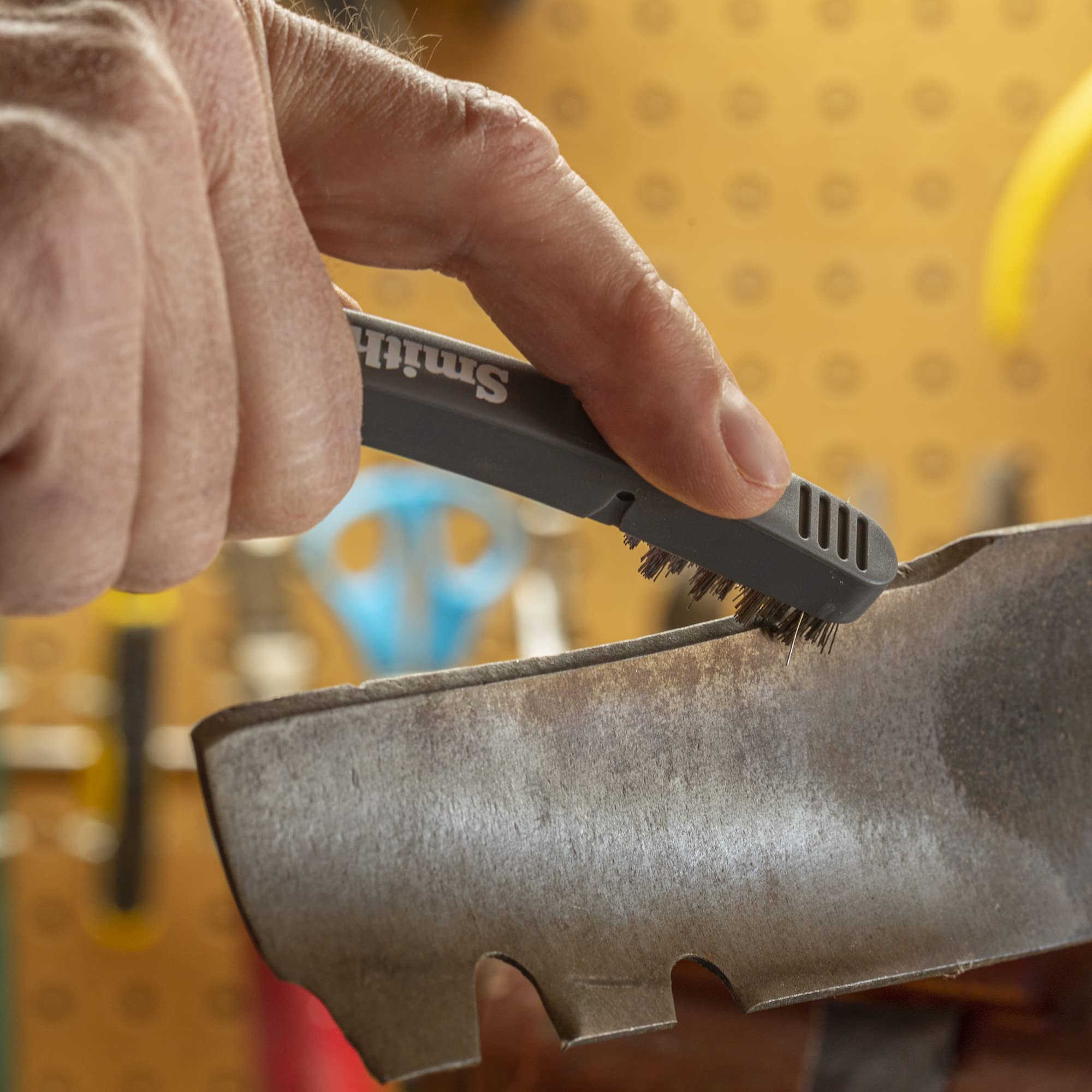 Smith's Lawn Mower Blade Sharpener in use on a mower blade