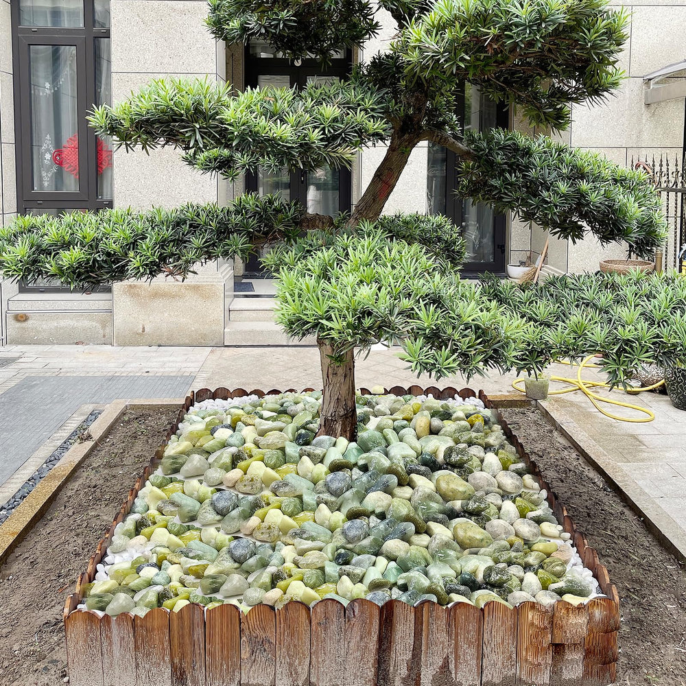 Smooth jade pebbles arranged in a flower bed