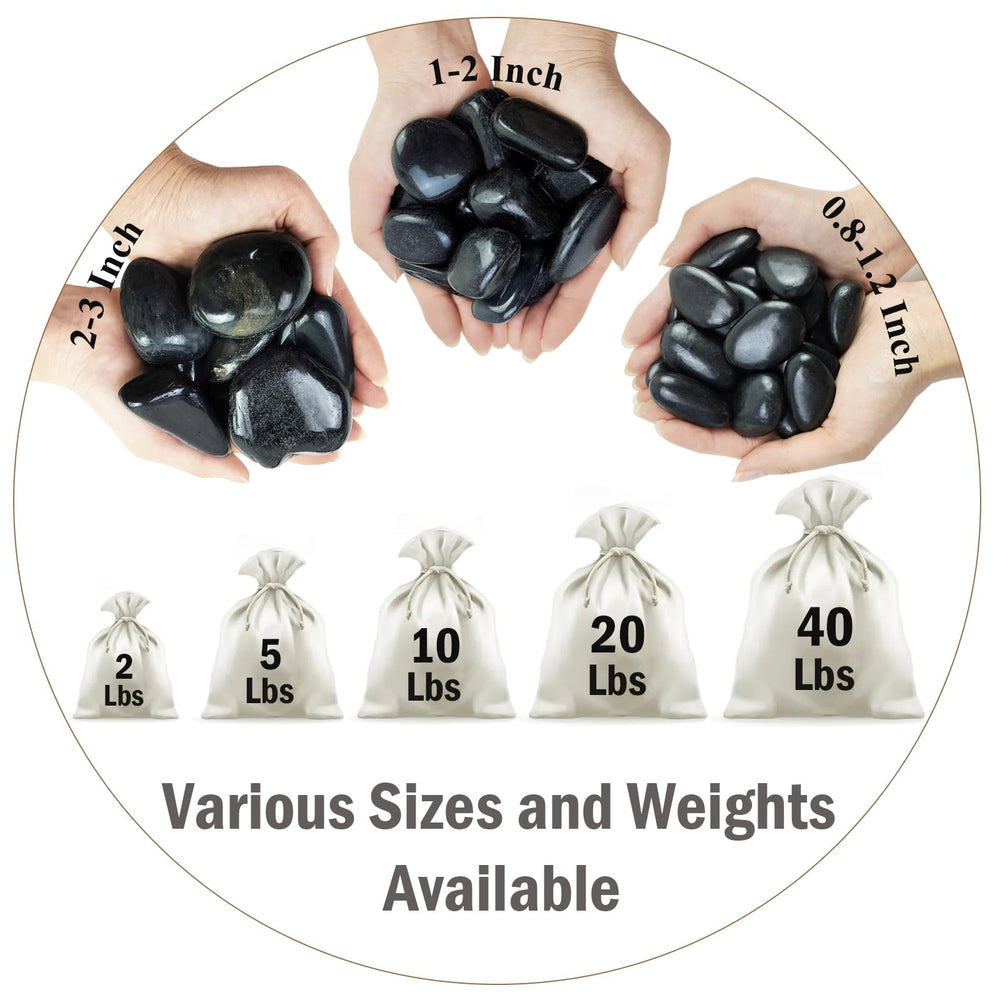 Smooth polished black pebbles in natural setting