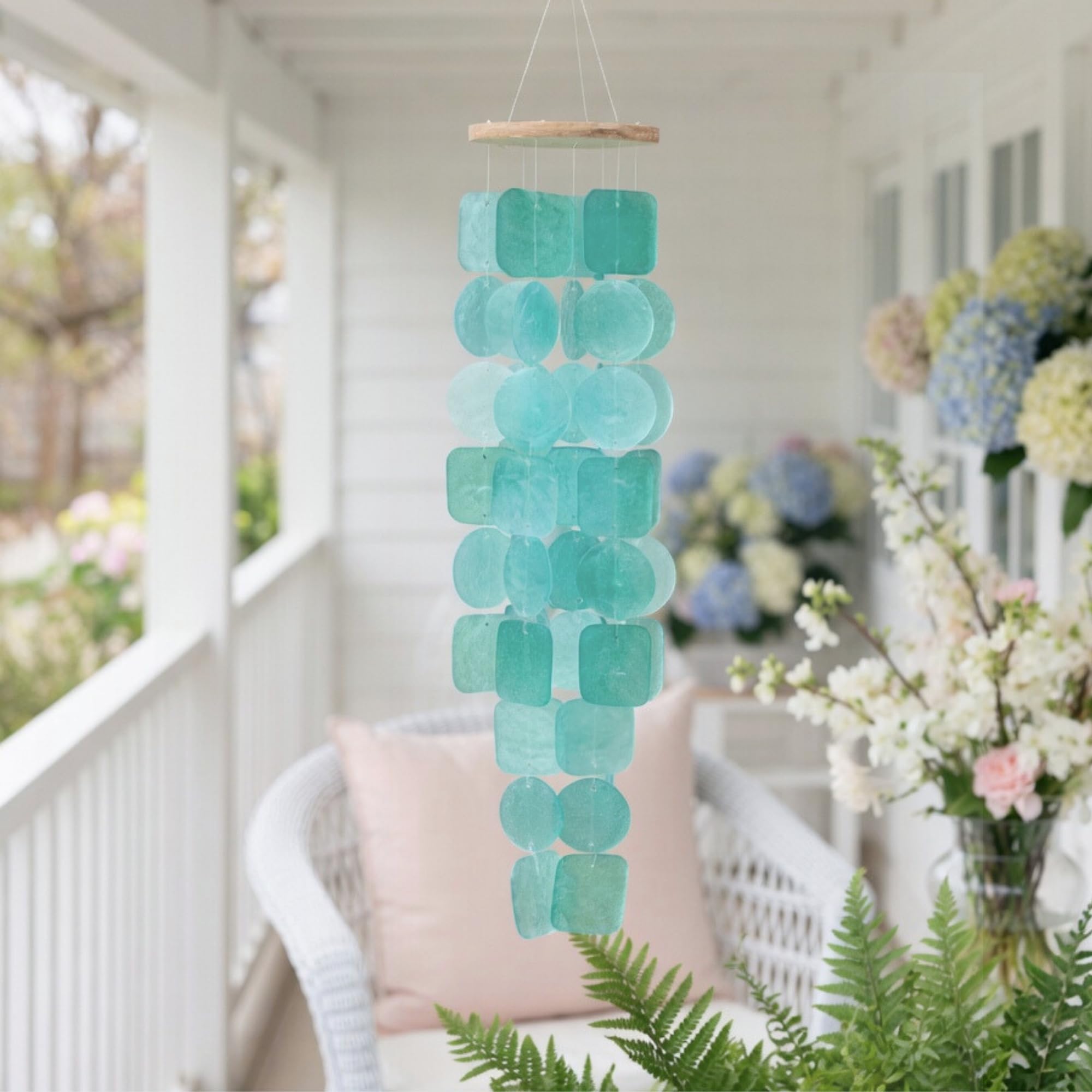 Solange & Frances Wind Chimes hanging in a garden