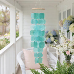 Solange & Frances Wind Chimes hanging in a garden