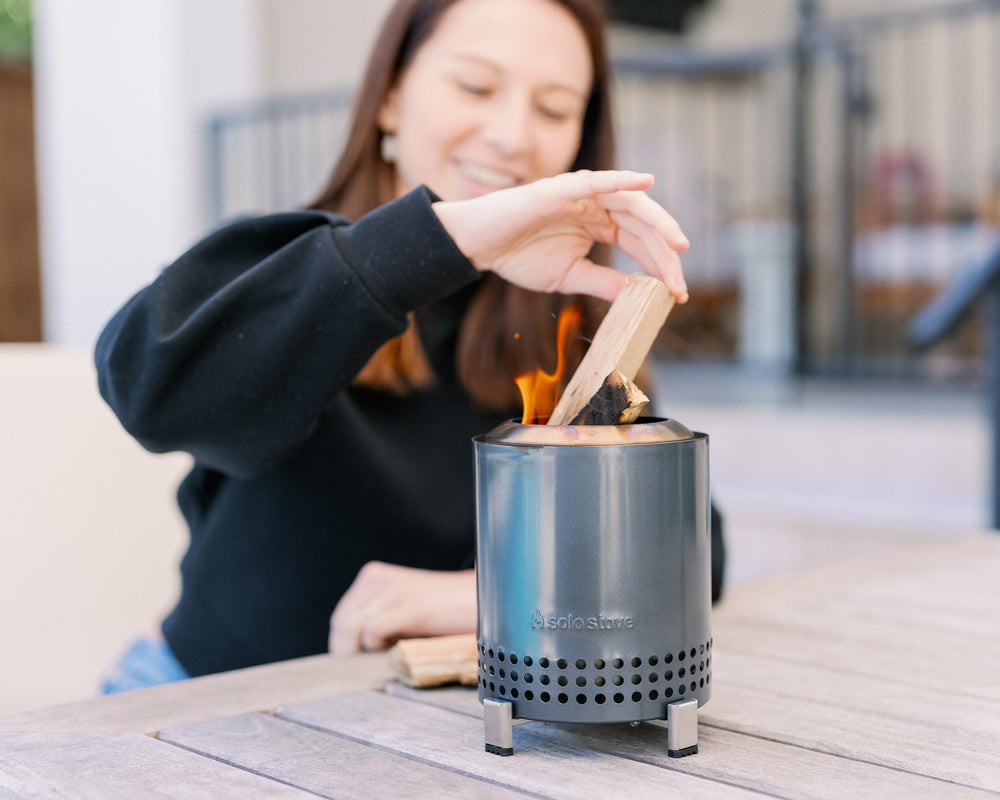 Solo Stove Mesa portable fire pit with flames visible