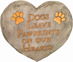 Spoontiques Dogs Leave Pawprints Stepping Stone displayed in a garden setting
