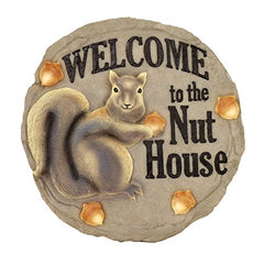 Spoontiques Nut House Stepping Stone placed in a garden setting