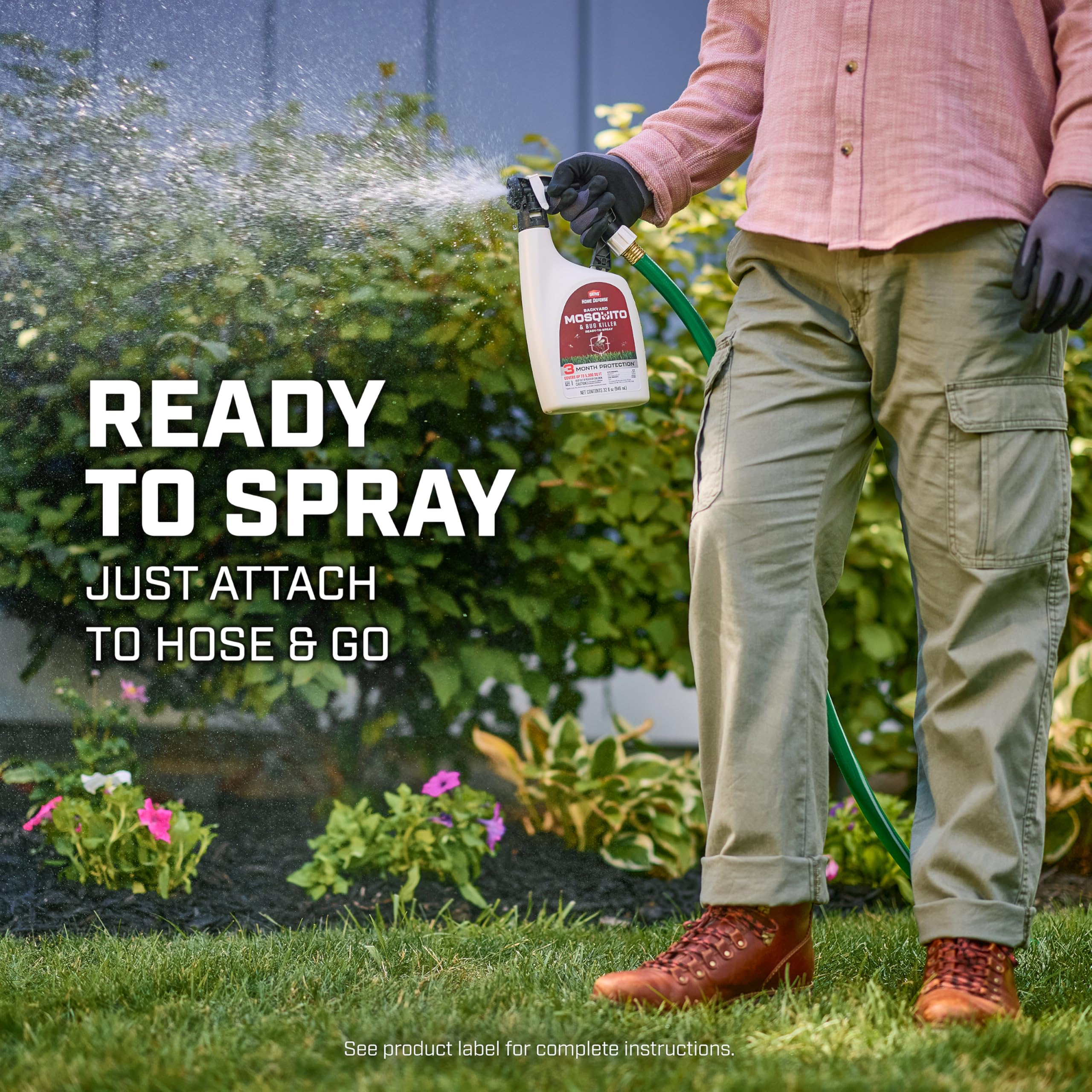 Spraying Ortho Backyard Mosquito Killer around a flower garden