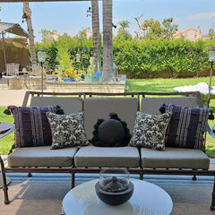 Sqodok cushion cover displayed on an outdoor sofa