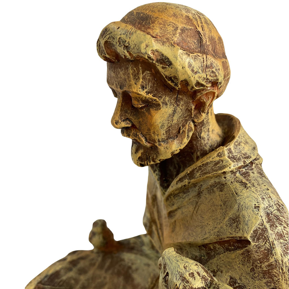 St. Francis statue with birds enjoying the feeder