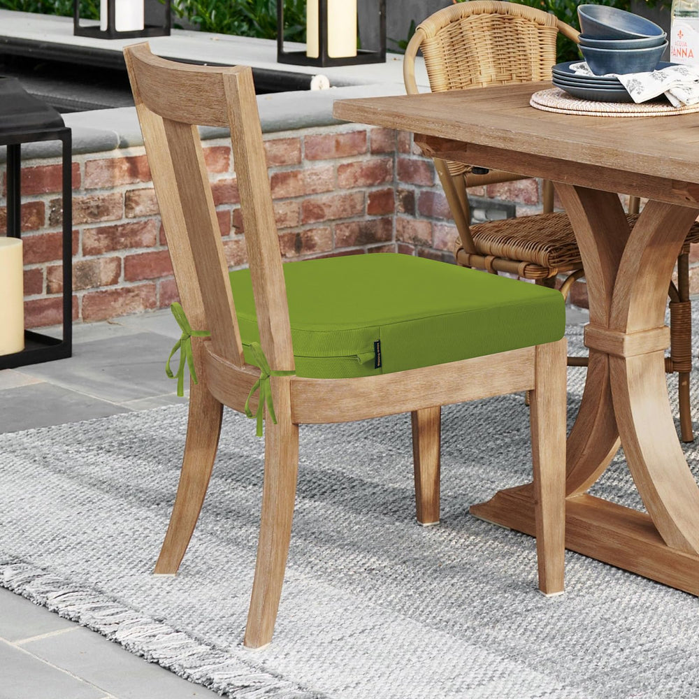 stacked outdoor chair cushions in vibrant green