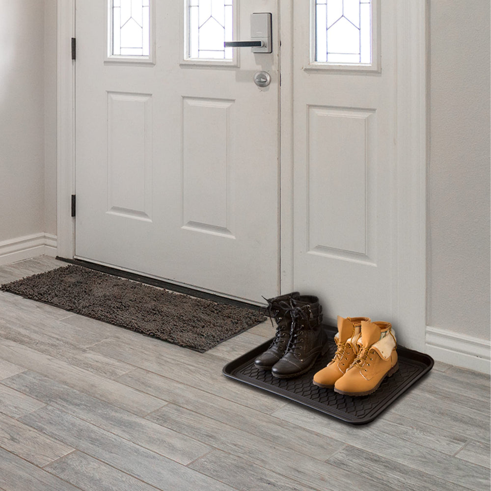 Stalwart Boot Tray displaying easy cleanup with water.