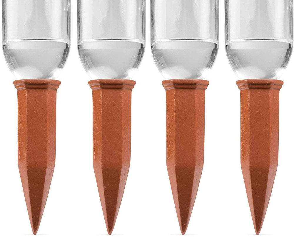 Terracotta self-watering stake inserted in a plant soil